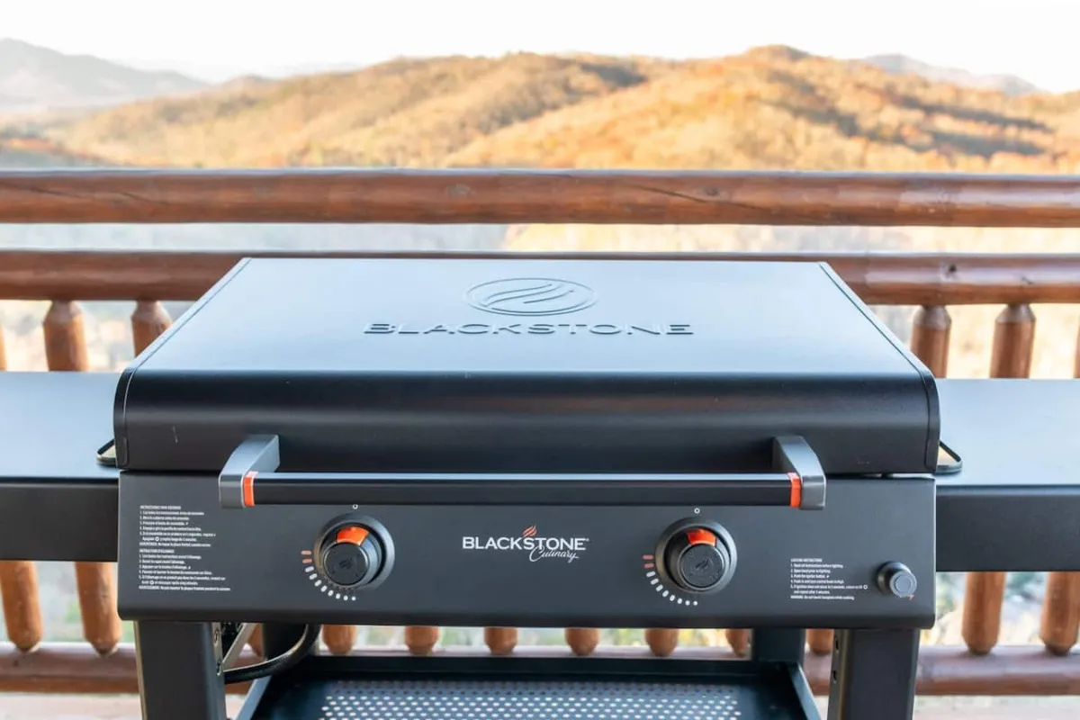 An exterior shot featuring a grill set against a backdrop of majestic mountain views, inviting guests to relax outdoors and savor nature. The image captures the seamless connection between the home and its natural surroundings.